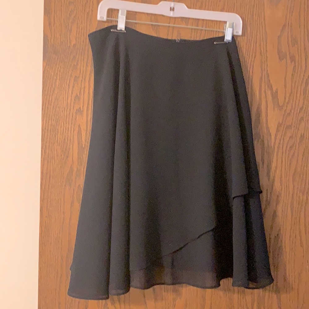 Black knee length skirt.No waistband.length  “waist” to hem 22”.Back zipper